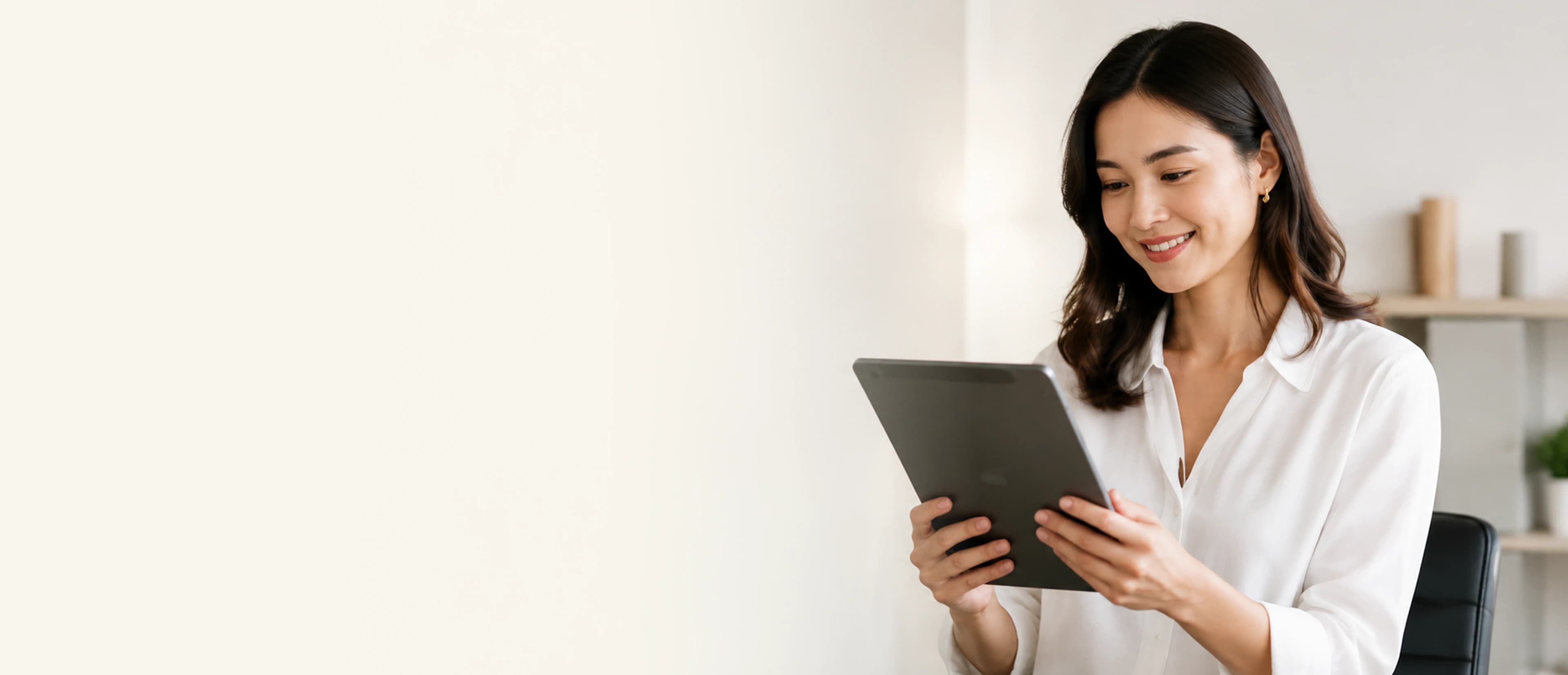 Mooselab team member reviewing work on a tablet in a bright office